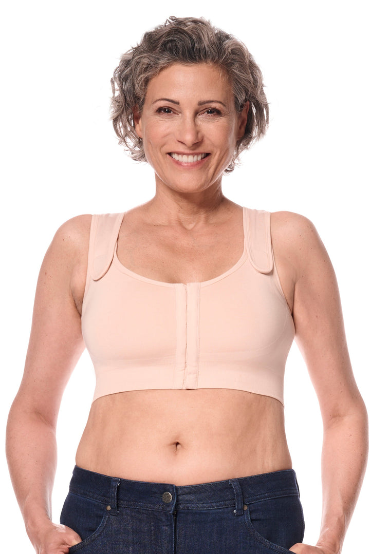Woman wearing a beige compression garment on a white background
