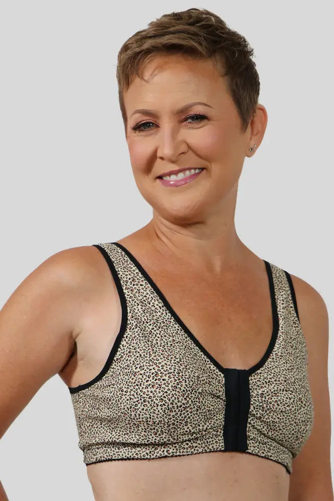 Woman wearing a patterned bra on a plain background