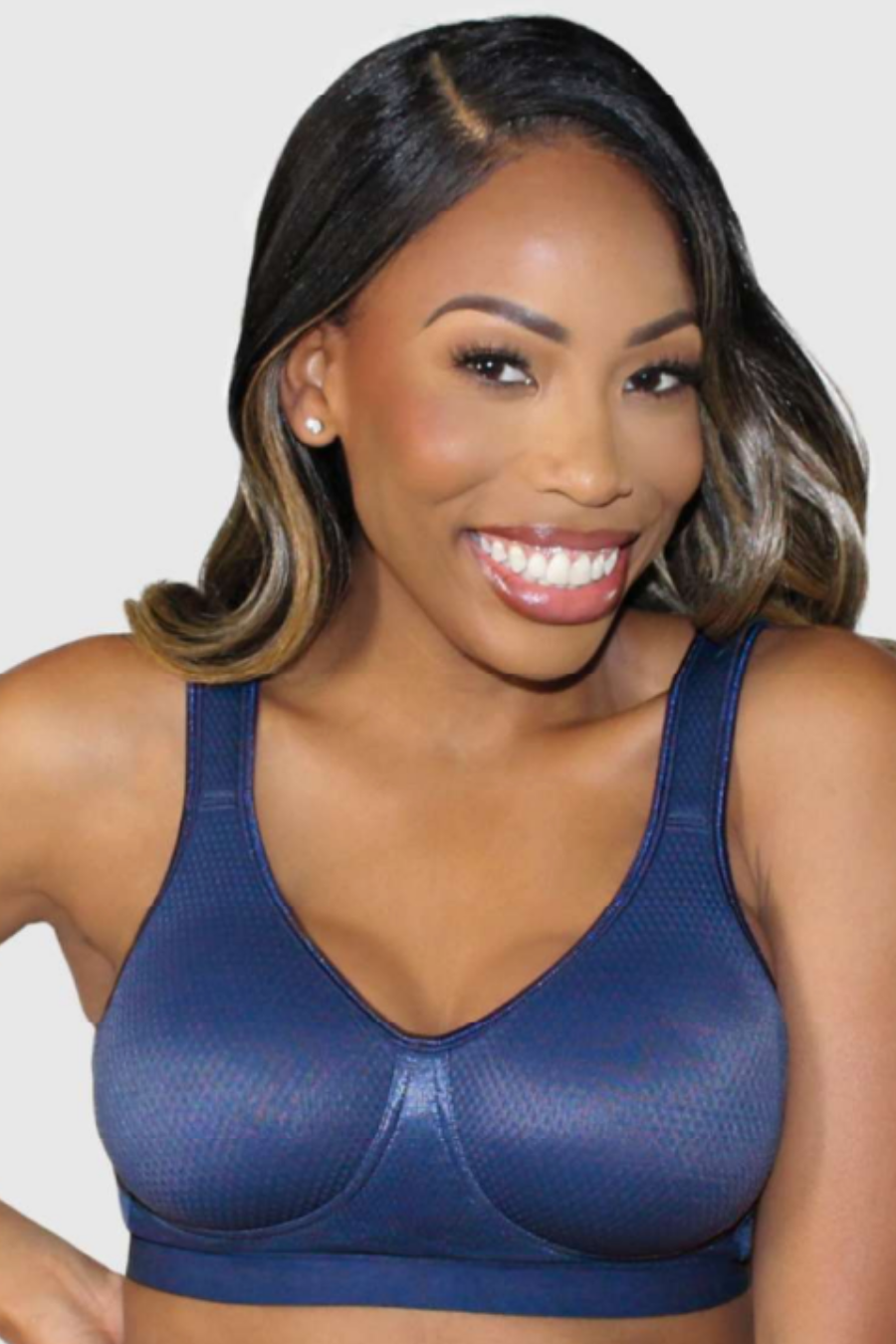 Woman wearing a blue mastectomy bra against a plain background