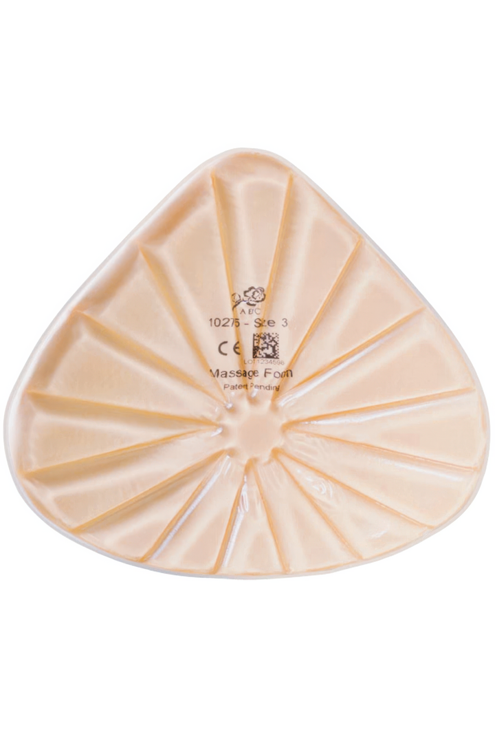Triangular beige massage breast form with branding and certification logos on a white background