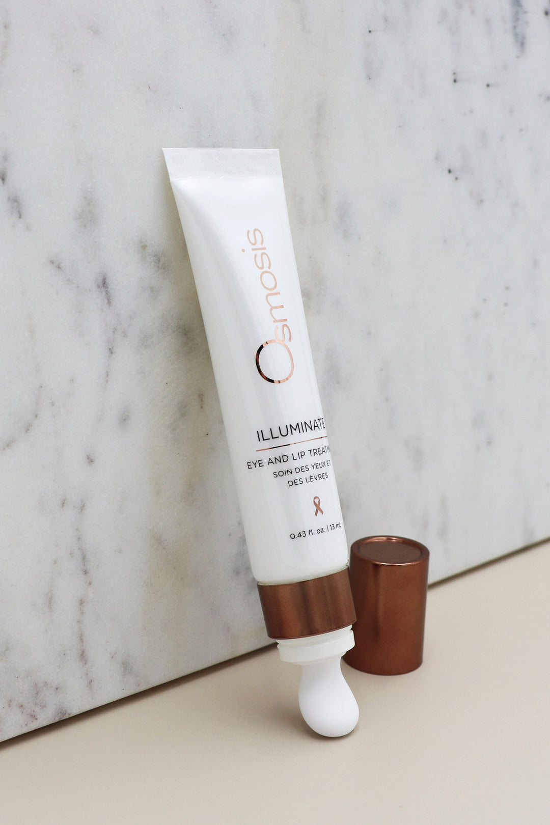 Cosmetic tube labeled 'Osmosis' on a marble surface