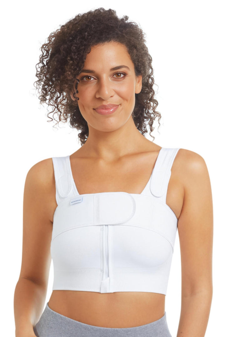 Woman wearing a white compression bra on a white background